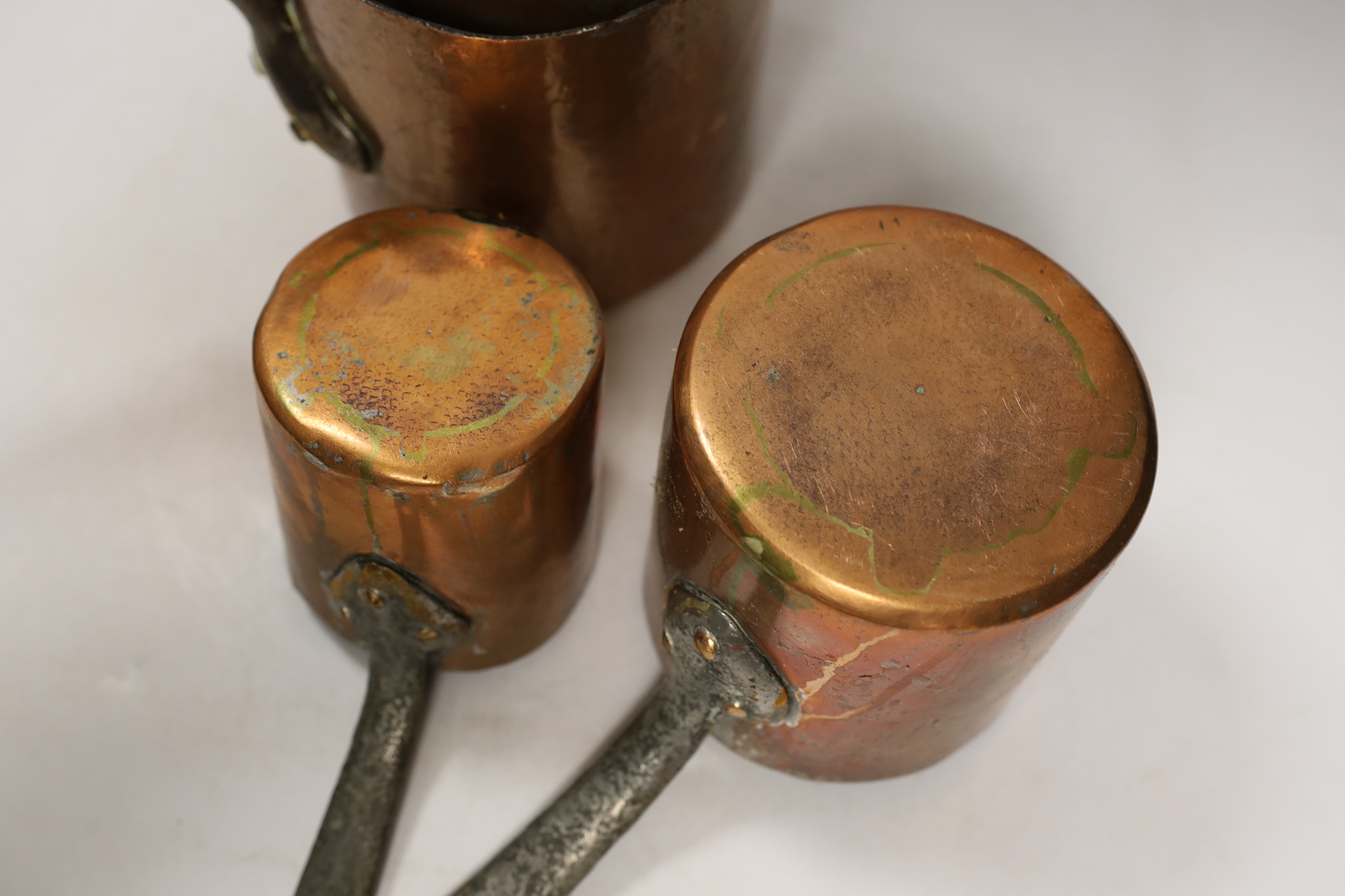 A set of five French graduated copper saucepans, largest 33cm wide